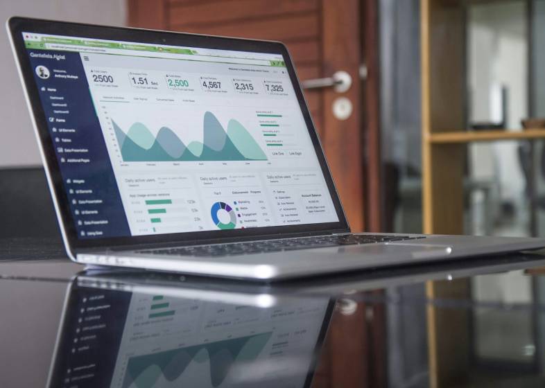 A laptop showing data on graphs